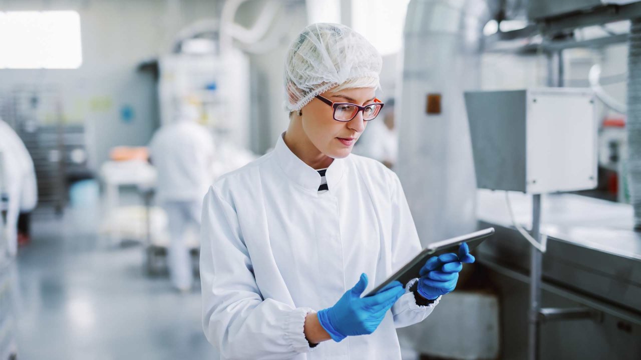 Worker looking an an ipad in a lab